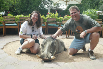 Lisa and Bill pose with Pumba