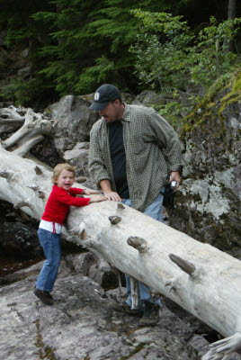 Emma and Adam climb on a log