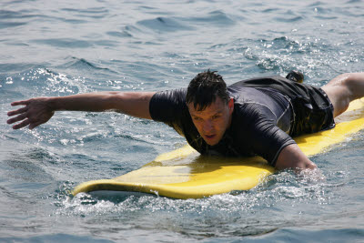 K.C. Paddling on a Surf Board