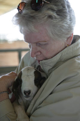 Dee snuggles up to a baby goat