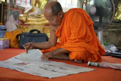 Buddhist Monk Reading the Paper at Wat Arun