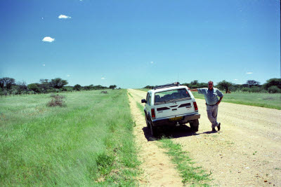 Andre poses next to his truck on a typical Namibia road