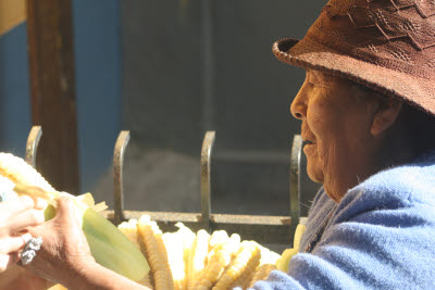 Peruvian women selling corn at the Ollantaytambo train station