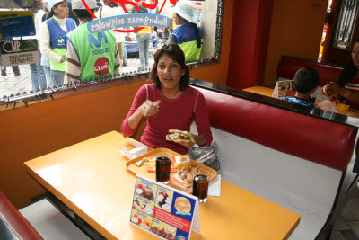 Amynah enjoys a hamberguesa at a knock-off Johnny Rockets