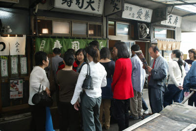 Diners wait for a table at this popular fishmarket restaurant
