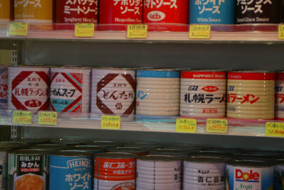 Large cans of sauces at a fishmarket stand