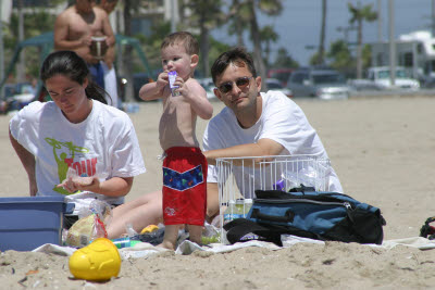 Mark, Sue, and Cooper picnic at the beach